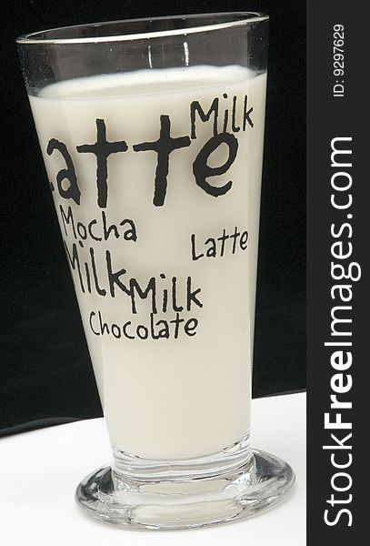Tall glass of milk on with a background. Tall glass of milk on with a background