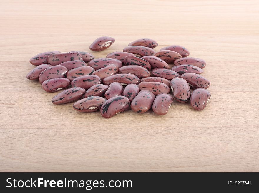 Runner bean seeds on wooden chopping board