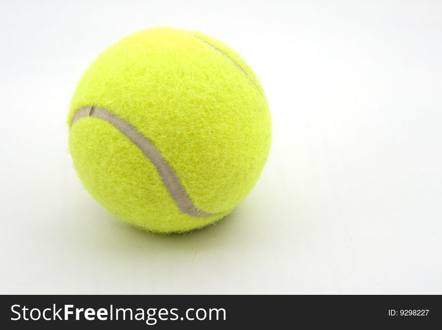 It's a tennis ball that is on a white background. It's a tennis ball that is on a white background.