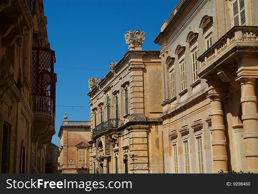 Classical building facades line a street in Mdina, Malta. Classical building facades line a street in Mdina, Malta