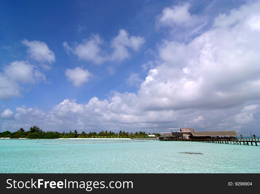 Exotic resort in Maldives under blue sky.