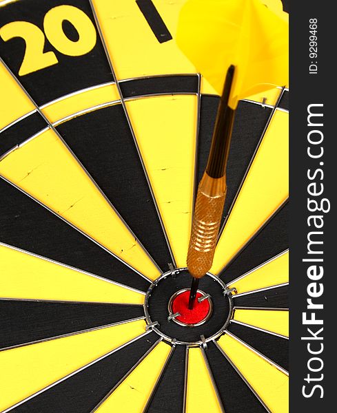Dart pinned to the center of a dartboard. Dart pinned to the center of a dartboard