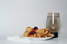Rolled Pancakes With Strawberry Jam And A Glass Of Water Royalty Free Stock Images Rolled Pancakes With Strawberry Jam And A Glass Of Water Royalty Free Stock Images