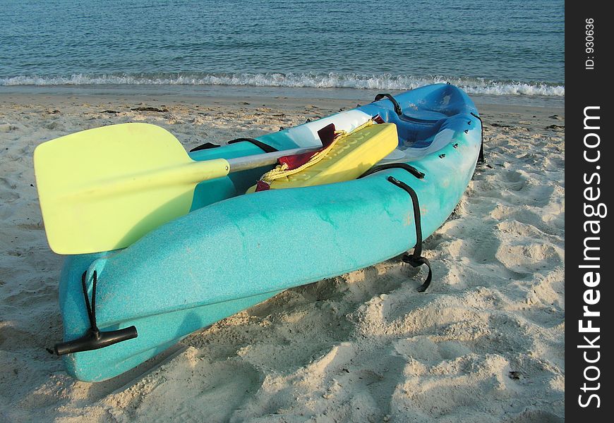 Sidelit by the setting sun, this is a rescue kayak used by lifeguards in sentosa resort, singapore. Sidelit by the setting sun, this is a rescue kayak used by lifeguards in sentosa resort, singapore