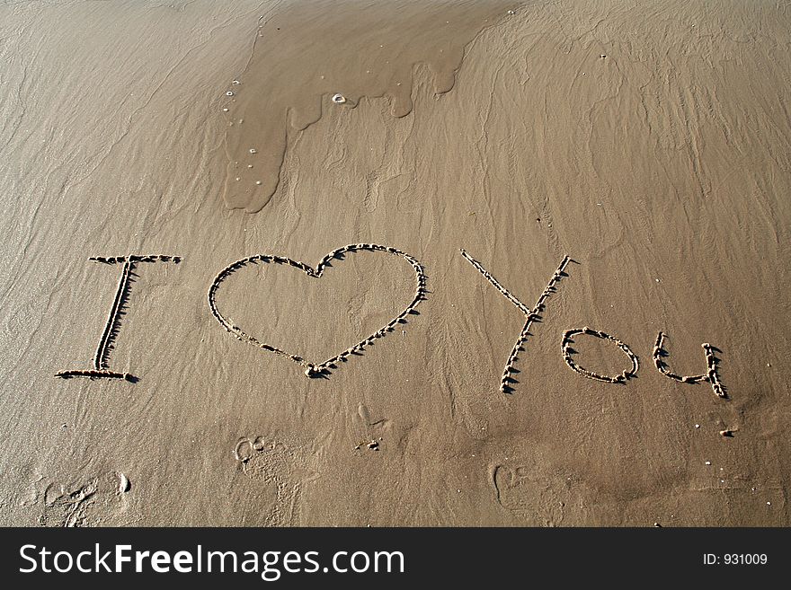 Printed words 'I love you' on sand. Printed words 'I love you' on sand