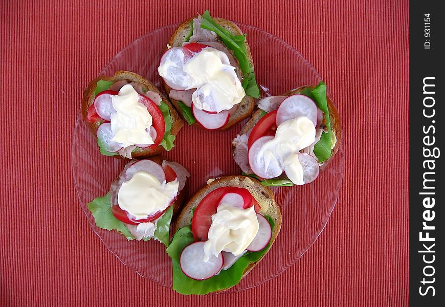 Fresh spring time sandwiches: bread, butter, lettuce, pork, tomato, radish and mayonnaise. Fresh spring time sandwiches: bread, butter, lettuce, pork, tomato, radish and mayonnaise