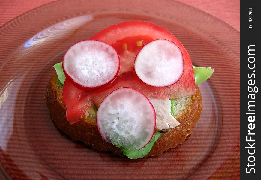 Fresh spring time sandwich:

bread, butter, lettuce, pork, tomato, radish