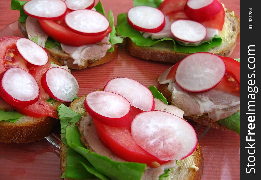 Fresh spring time sandwiches:

bread, butter, lettuce, pork, tomato, radish