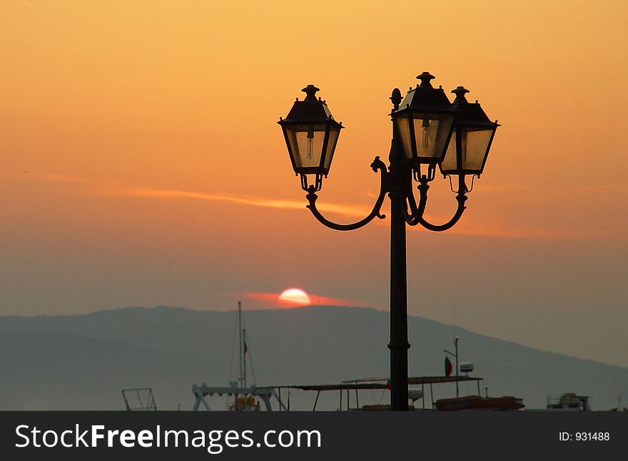 Street lamp by the sea when sun is rising