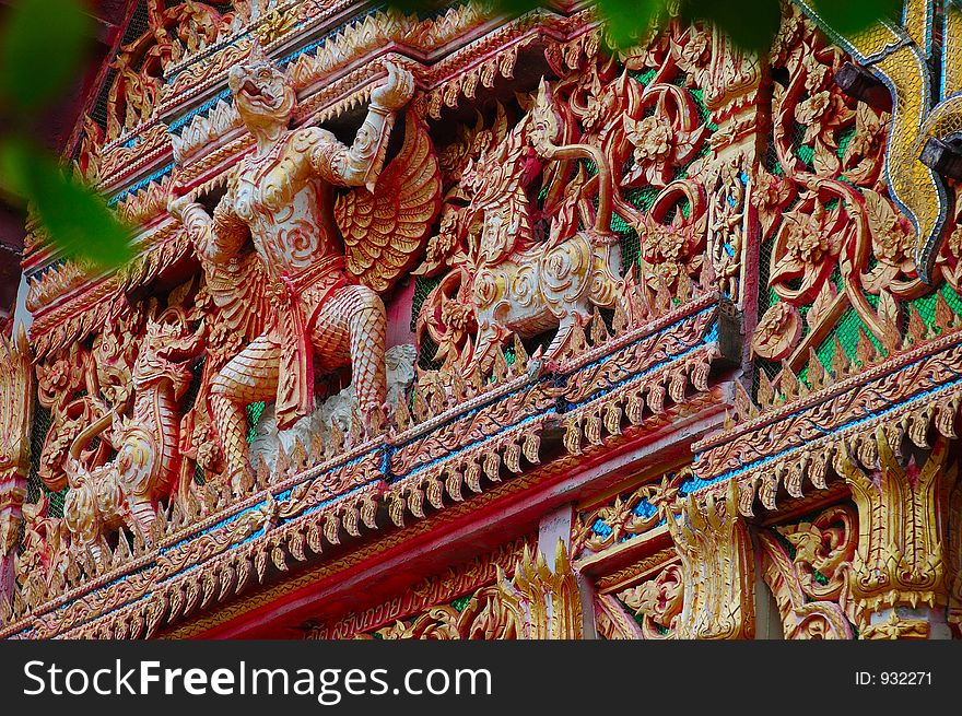 Birdman and other figures adorn the wall of a buddhist temple in Surat Thani, Thailand. Birdman and other figures adorn the wall of a buddhist temple in Surat Thani, Thailand.