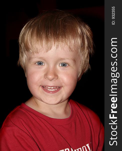 Happy boy on black background