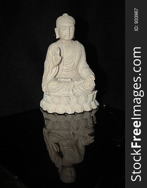 Full-sized White sitting Buddha with reflection. Full-sized White sitting Buddha with reflection