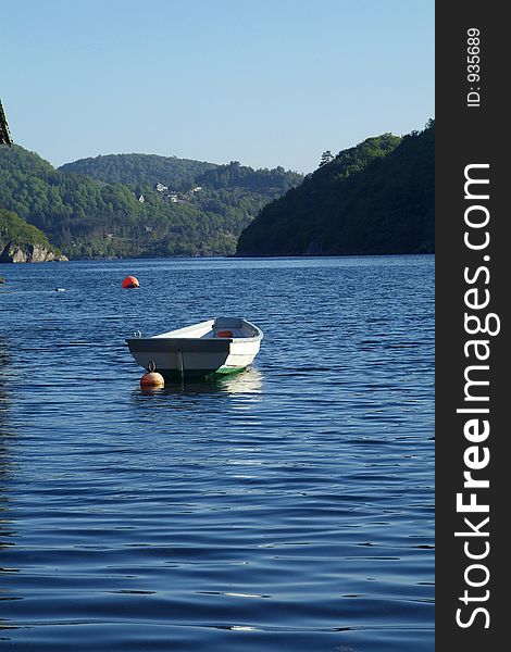 Traditional dinghy and old boathouse in a fjord on the Norwegian south coast