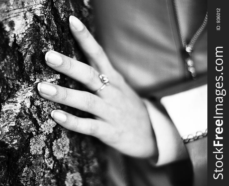 A female fingers touching the tree