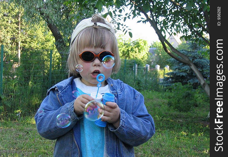 A girl blowing soap bubbles