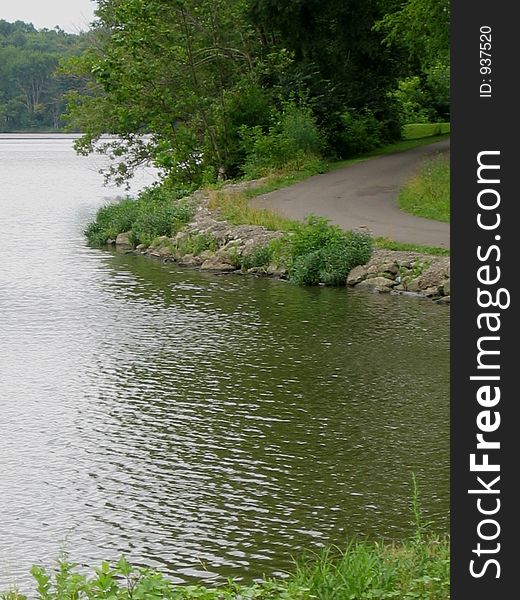 Road on the shore of lake at Stonelick State Park, Ohio