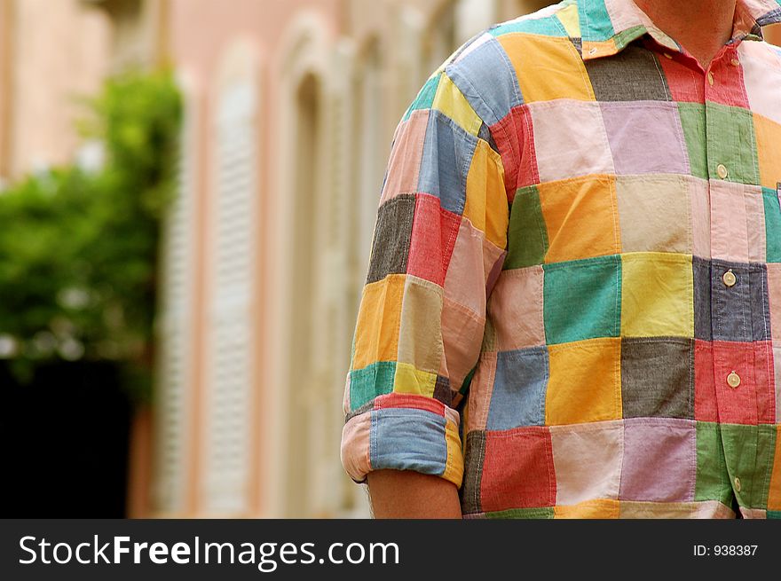 Man wearing colourful shirt walking through street in Saint Tropez. Man wearing colourful shirt walking through street in Saint Tropez