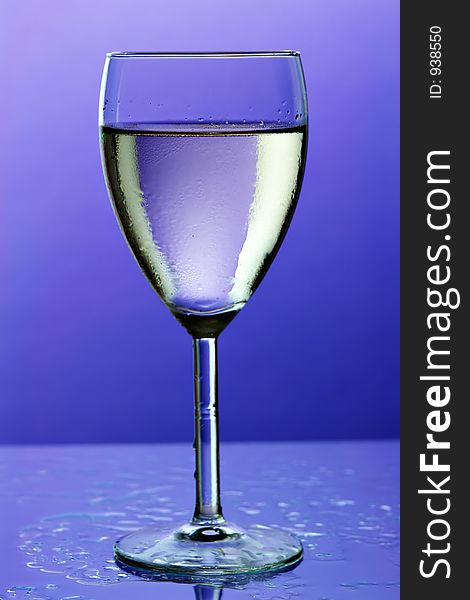 Glass of wine on blue background