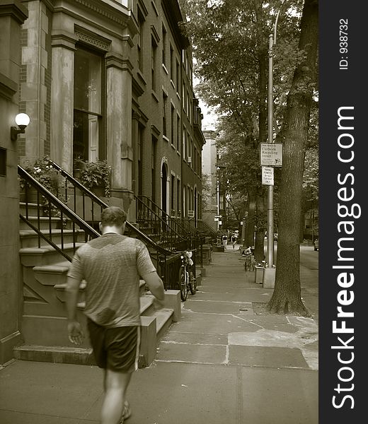 Man walking in historic brooklyn in sepia tone