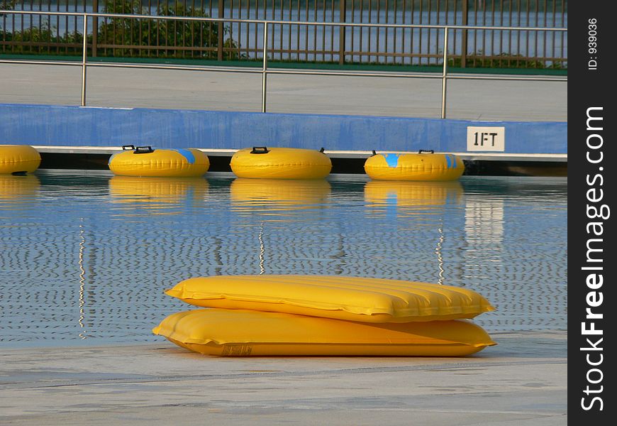 The local wave pool had closed, and these rafts were waiting to be put away for the night. The local wave pool had closed, and these rafts were waiting to be put away for the night.