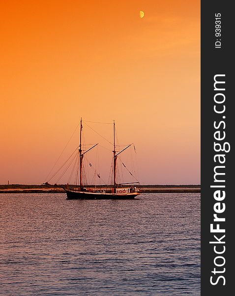 Sailboat returning to docks after sunset