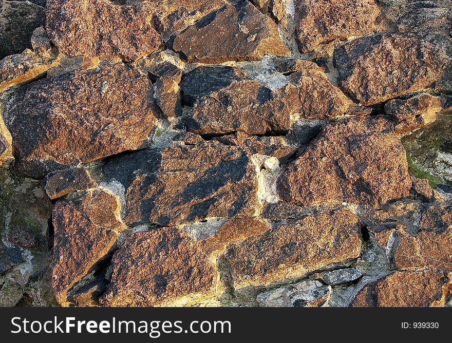 Natural stone wall at the sunset