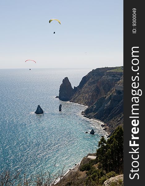 Paraplane fly on by sea and mountain