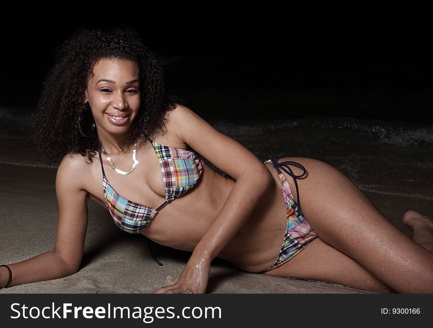 Young woman on the beach at night