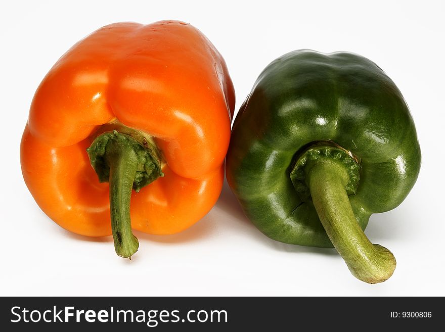 Two pepper, are photographed on a white background. Two pepper, are photographed on a white background