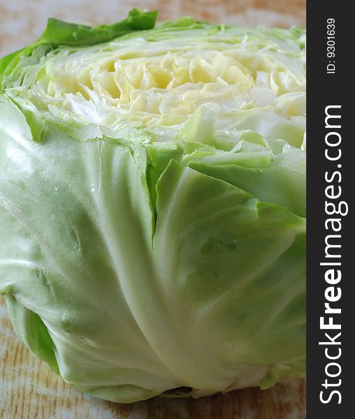 The cut  white cabbage lies on a table