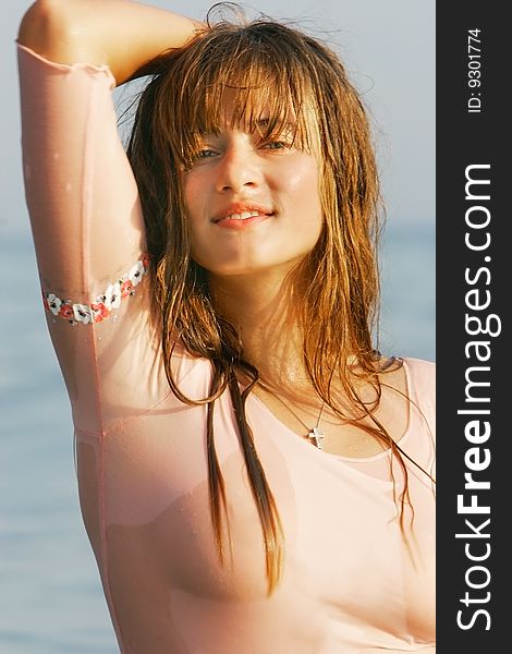 Attractive young girl with wet hair over sea background