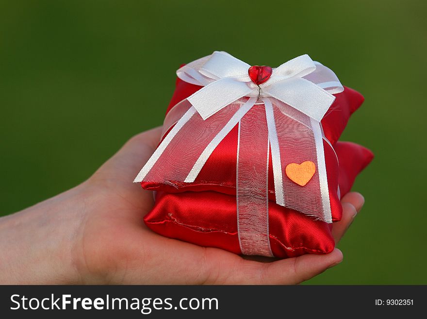 Red gift with heart and green backround. Red gift with heart and green backround