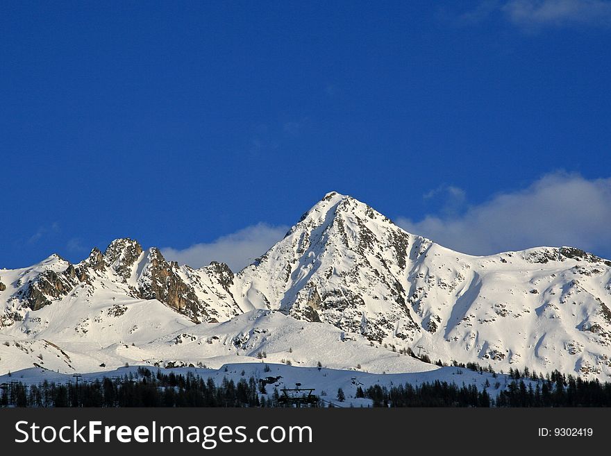 Snow covered mountains with a blue sky