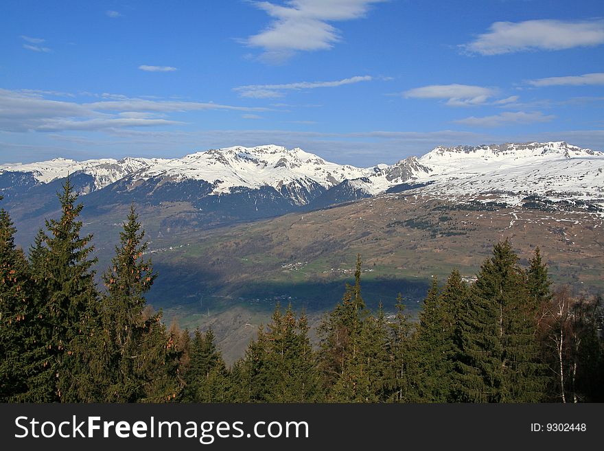 Snow covered mountains with a blue sky