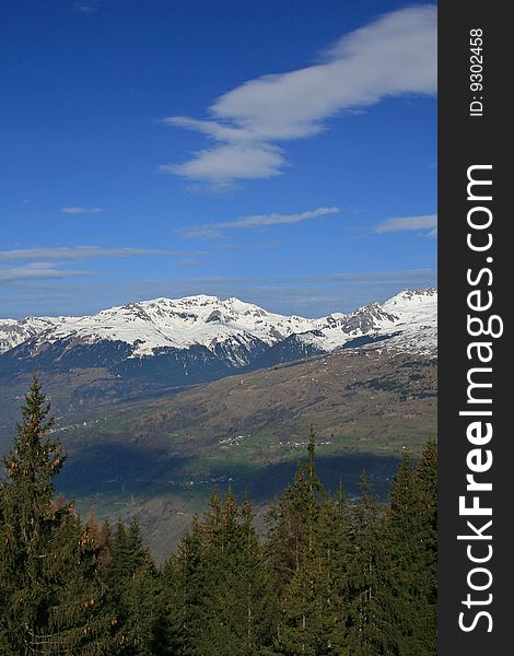 Snow covered mountains with a blue sky