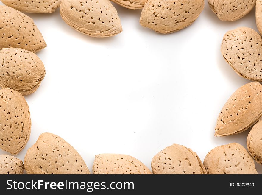 Almonds arranged forming a frame, in white background. Almonds arranged forming a frame, in white background.