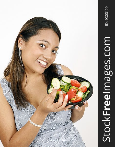 Sweet and pretty girl eating salad and posing