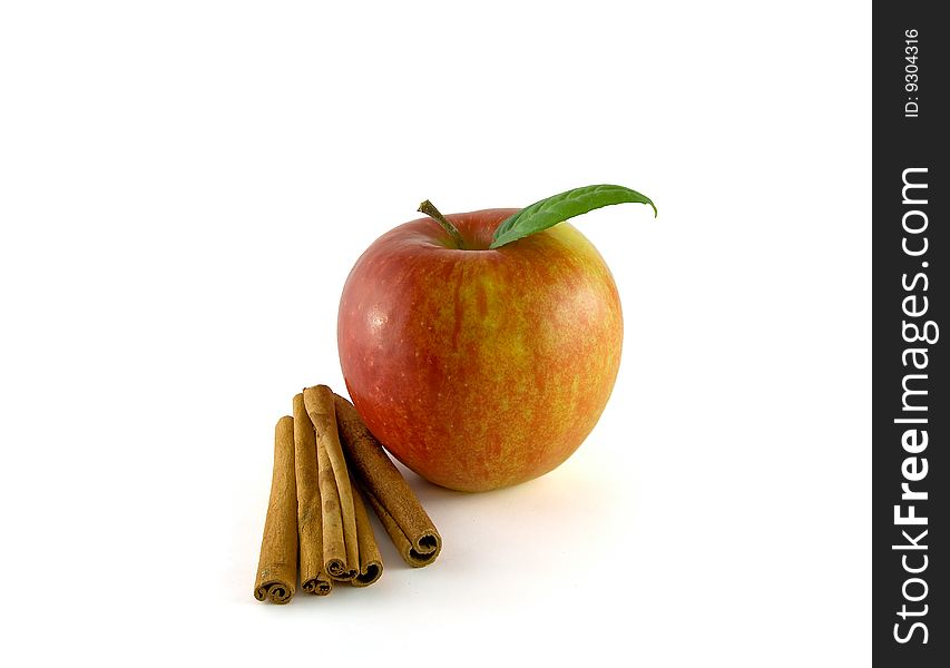 Red apple with cinnamon on the white background