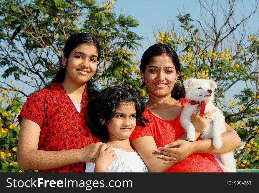 Three girls and dog