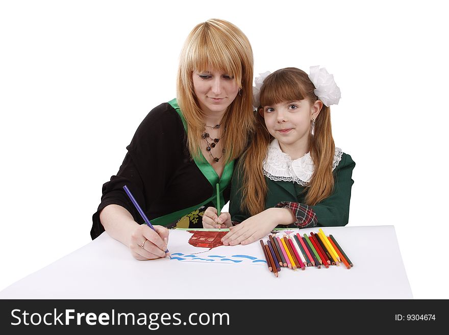 Mother and her young daughter drawing together, set of felt tips on the table. Schoolgirl is  drawing  in pencil. Woman is painting the picture. Isolated over white background. Mother and her young daughter drawing together, set of felt tips on the table. Schoolgirl is  drawing  in pencil. Woman is painting the picture. Isolated over white background.