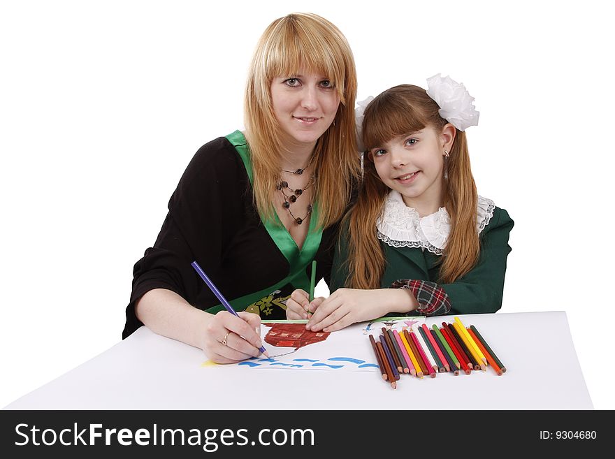 Mother and her young daughter drawing together, set of felt tips on the table. Schoolgirl is drawing in pencil. Woman is painting the picture. Isolated over white background. Mother and her young daughter drawing together, set of felt tips on the table. Schoolgirl is drawing in pencil. Woman is painting the picture. Isolated over white background.