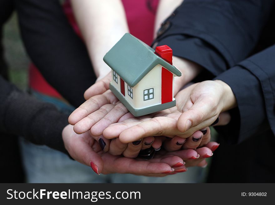 Model of the house in human hands