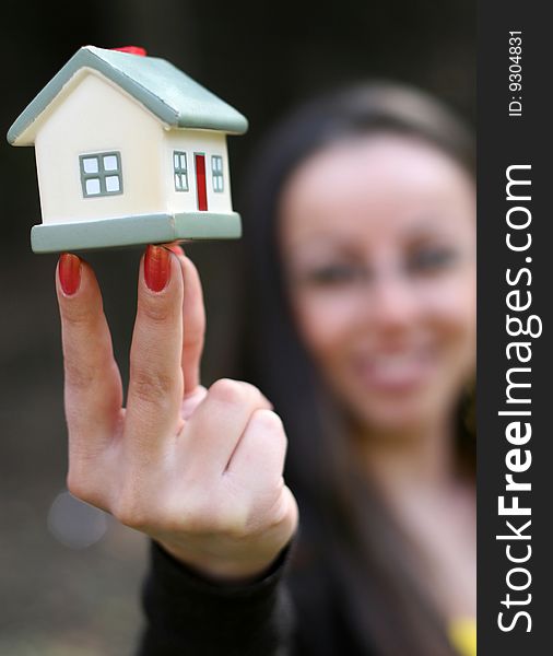 Woman holding house in hand. Woman holding house in hand
