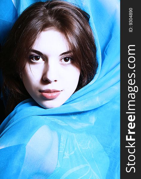 Portrait of the beautiful girl with a blue scarf on a neck. Portrait of the beautiful girl with a blue scarf on a neck.
