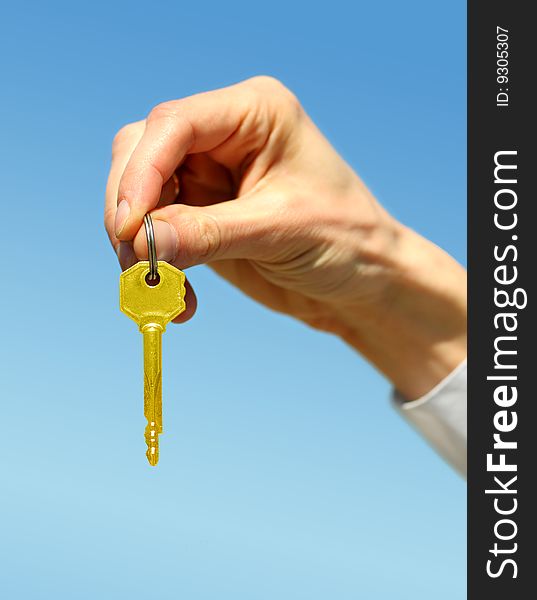 Key in a palm over white background