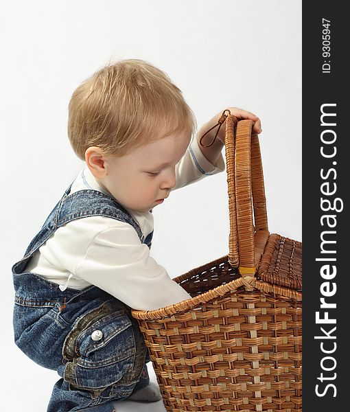 Funny little boy looking into the basket