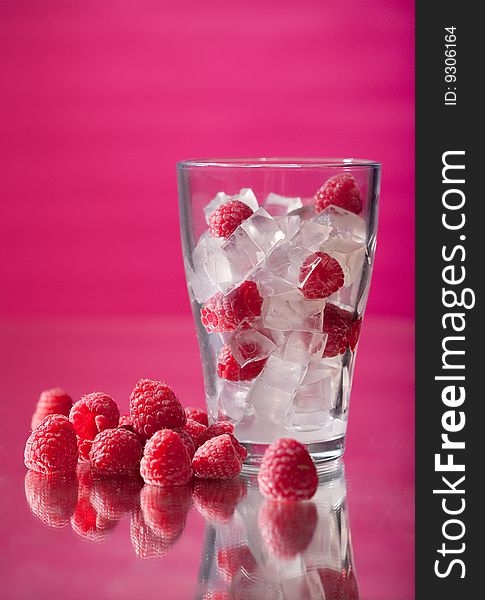 Juicy fresh raspberry in a glass with ice