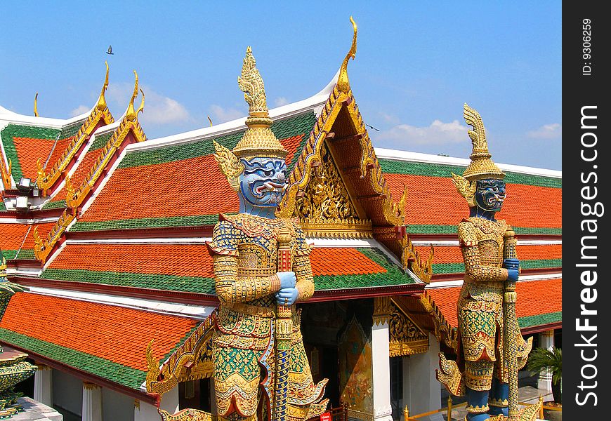 Two sculptures at an input. . On beautiful asia travel .With a sword in hands.Colour roof. Two sculptures at an input. . On beautiful asia travel .With a sword in hands.Colour roof