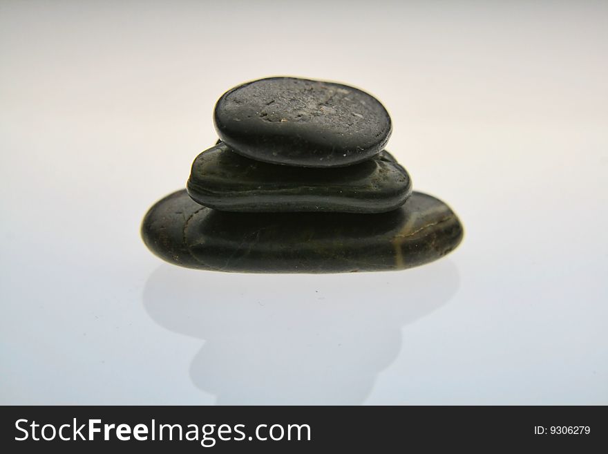 Small stones balanced carefully on top of one another making a stack. Small stones balanced carefully on top of one another making a stack.