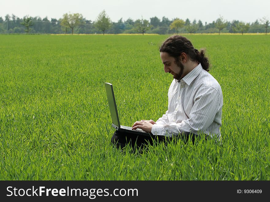 Man Sitting On The Grass, Working